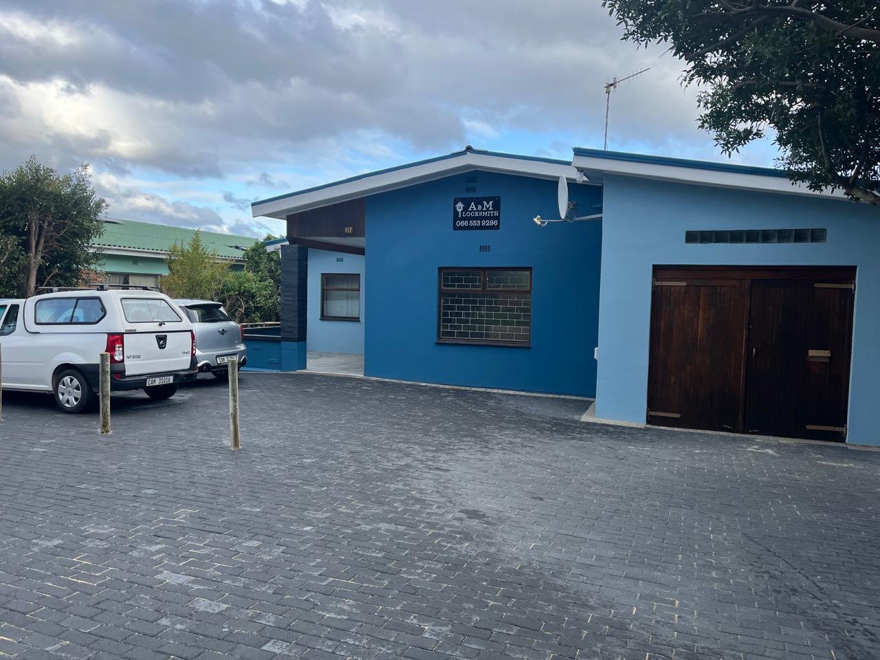 The A & M Locksmith shop seen from the paved parking area on Main Road