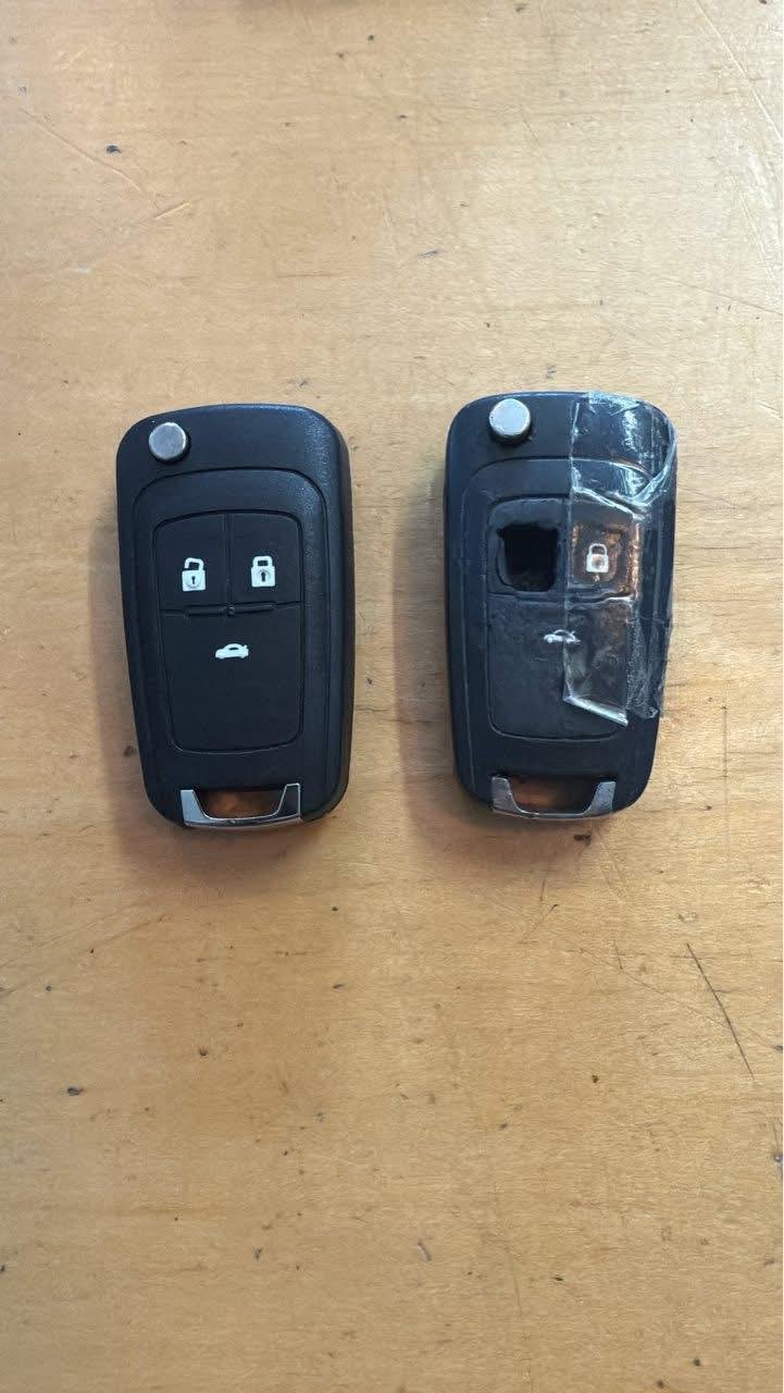 A new flip-key shell beside the cracked, taped-up shell it replaced